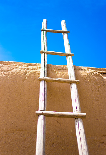 Santa Fe Style: Kiva Ladder Against Adobe Wall, Blue Sky