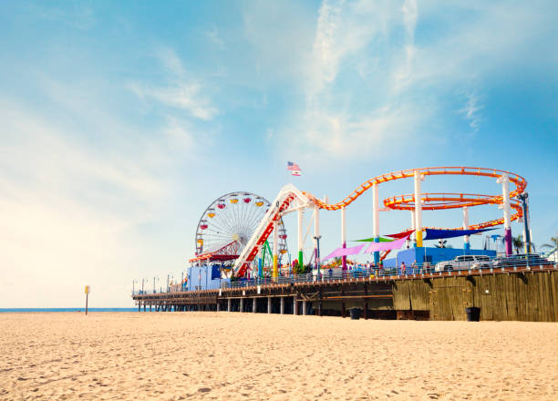Santa Monica beach and Pier View from the beach at Santa Monica pier boardwalk stock pictures, royalty-free photos & images