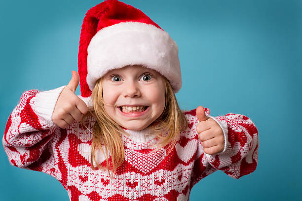 Santa's Little Helper Giving Thumbs Up Sign stock photo