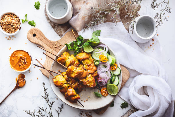 Satay chicken skewer and peanut sauce for summer stock photo