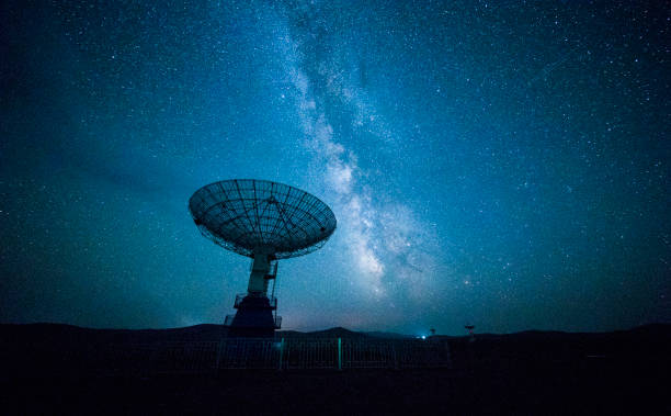 Satellite dish under a starry sky stock photo