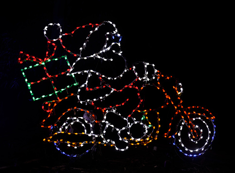 Satna Claus riding a motorcycle with Christmas gift. Fantasy of Lights in Los Gatos, California.