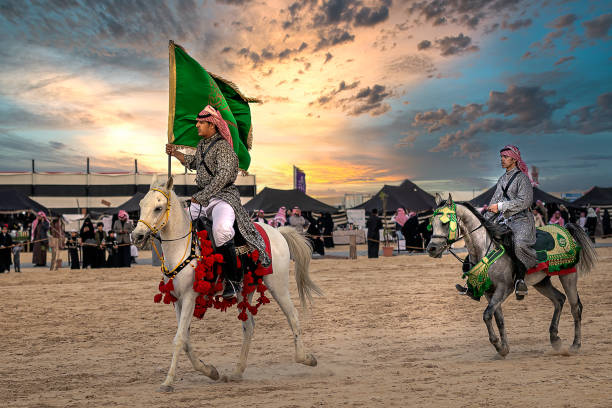 Saudi Arab Horse rider with Saudi Arabia national flag on traditional desert safari festival in abqaiq Saudi Arabia. 10-Jan-2020 stock photo