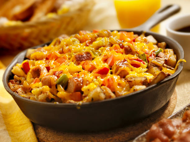 Sausage Pan Scrambler with Cheddar Cheese "Sausage Pan Scrambler with Hash Brown Potatoes, Scrambled Eggs, Red and Green Peppers, Toast and Fresh Berries- Photographed on Hasselblad H3D2-39mb Camera" hash brown photos stock pictures, royalty-free photos & images
