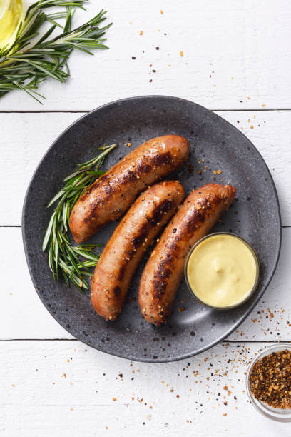 Sausages with dijon mustard sauce and seasoning stock photo