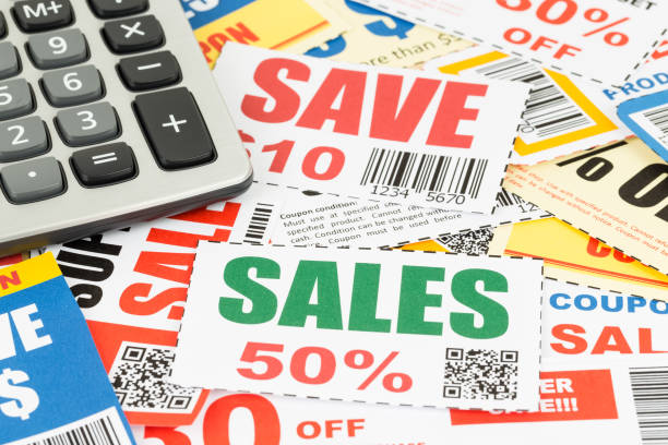 Saving discount coupon voucher with calculator, coupons are mock-up stock photo
