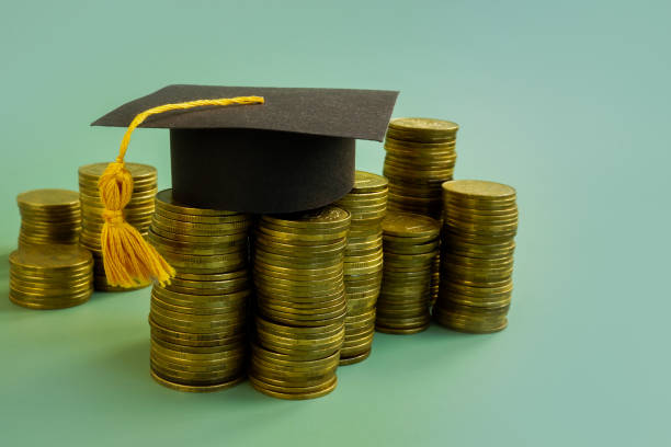Savings for education concept. Graduation cap and money. Savings for education concept. Graduation cap and money. student debt stock pictures, royalty-free photos & images