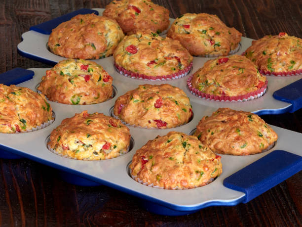 Savory muffins with cheddar, spinach and red peppers stock photo