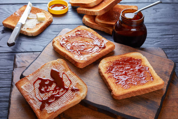 savory toasts with butter and yeast extract stock photo