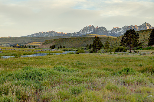 Pastureland in front of the world famous sawtooth mountains with the Salmon river flowing through, near Stanley, Idaho.
