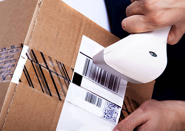 Scanning parcel Delivery worker scanning parcel for shipmenthttp://i705.photobucket.com/albums/ww60/Vozd500/konceptir.jpg?t=1288788715 labeling stock pictures, royalty-free photos & images