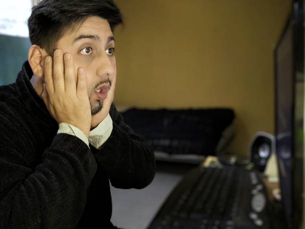 Scared in front of the pc stock photo