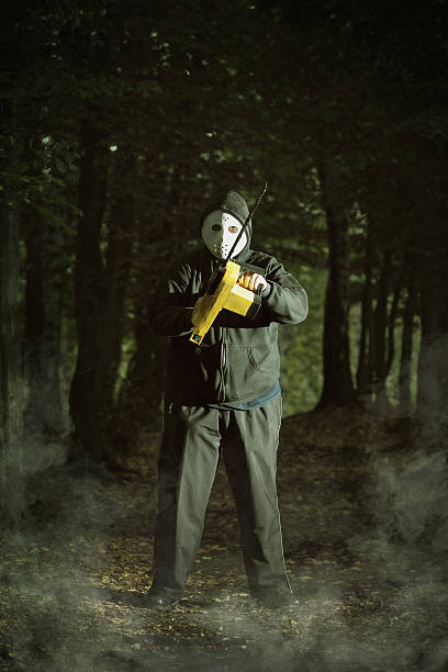 Scaring maniac with chainsaw stock photo