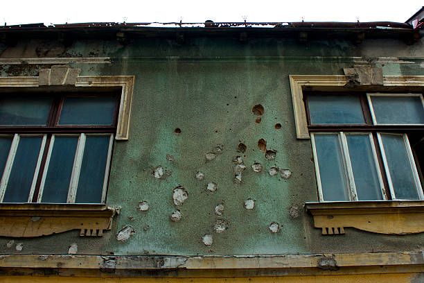 Scars of war in Mostar A bullet riddled builing in downtown Mostar, Bosnia. bosnia and hercegovina stock pictures, royalty-free photos & images