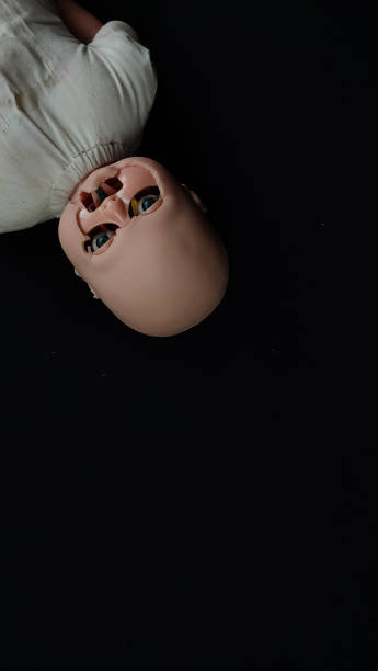 Scary broken baby doll on black background. Scary baby doll. Creepy baby doll. Scary broken baby doll on black background. Scary baby doll. Creepy baby doll. broken doll 1 stock pictures, royalty-free photos & images
