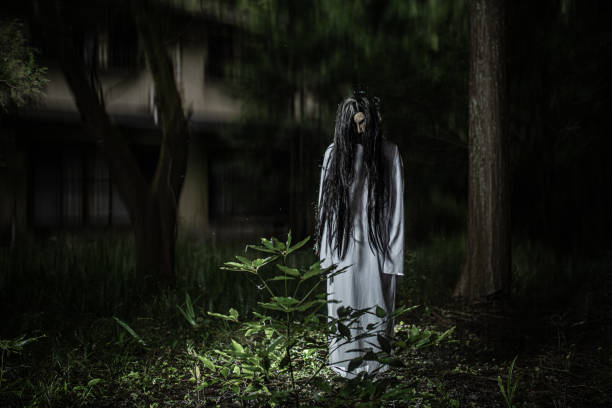 Scary Japanese witch ghost with abandoned house in forest stock photo