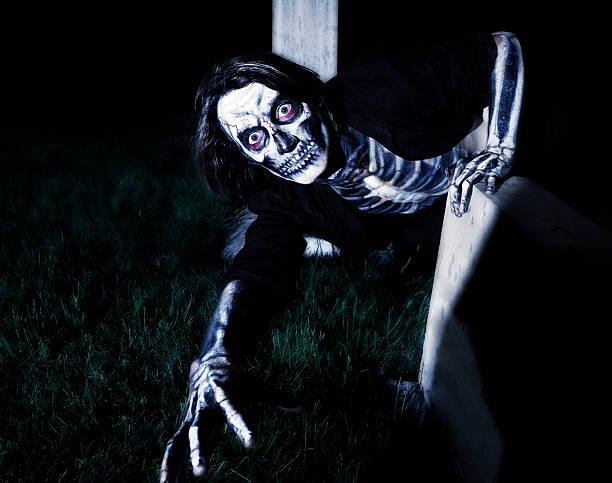 Scary Skeleton Crawling on Ground at Night stock photo