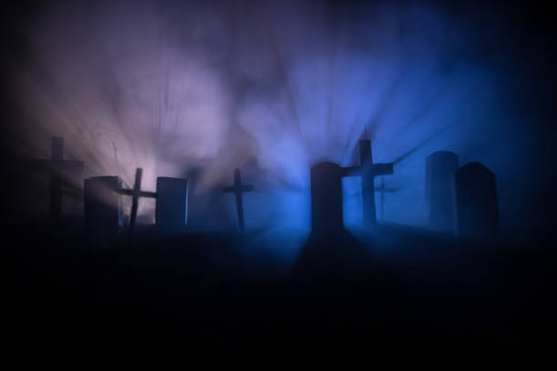 Scary view of zombies at cemetery dead tree, moon, church and spooky cloudy sky with fog, Horror Halloween concept with glowing pumpkin. Selective focus stock photo