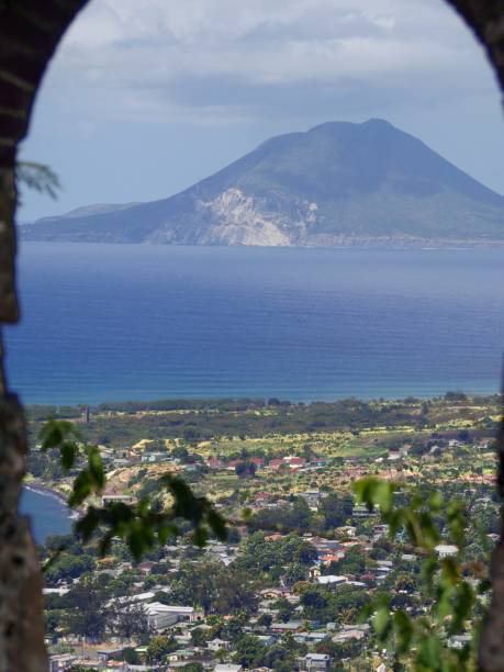 Scenic coastal view with Nevis in the distance, seen through an arch from  St. Kitts, Caribbean. stock photo