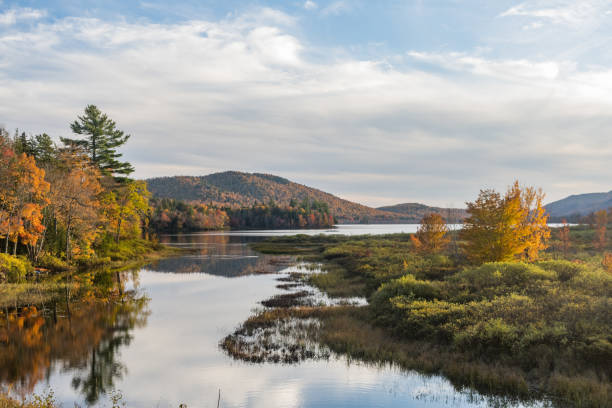 Scenic Lewey Lake Landscape in the New York Adirondack Mountains in Autumn At dusk Lewey Lake reflects mountains, trees and sky in the Adirondack Mountains State Park in New York, USA. adirondack state park stock pictures, royalty-free photos & images