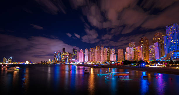 Scenic night view of the skyline of the Dubai Marina district with it's tall skyscrapers raising next to the beach and the waterfront, Dubai, UAE stock photo