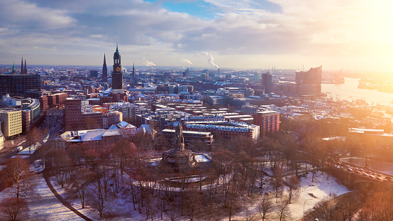 Scenic panorama view from Dancing Towers over Hamburg under snow in winter with St. Michael's Church (German: St. Michaelis), Speicherstadt, river Elbe and New Philharmonic Theater, Elbphilharmony.