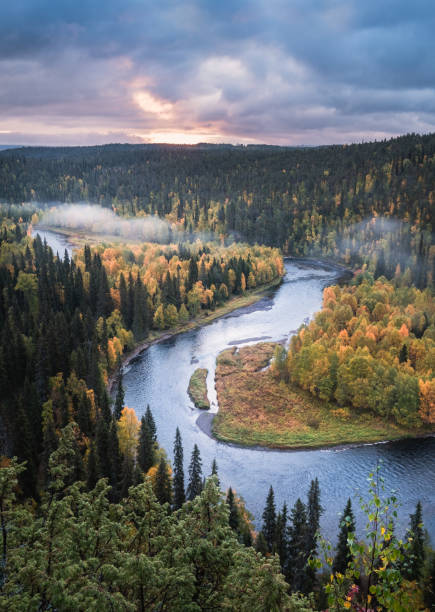 Photo of Scenic river landscape with fall colors woodland at autumn morning in National Park, Finland