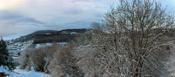 Scenic snow-covered trees and view towards Pontypool in the Welsh Valleys stock photo