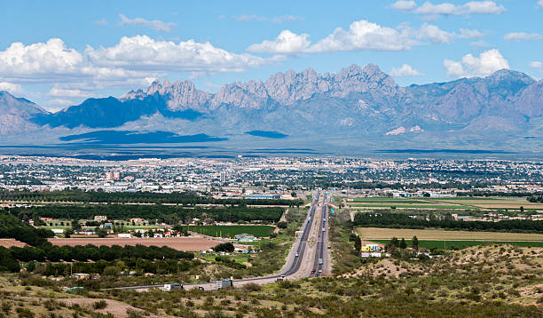 Scenic View of Las Cruces, New Mexico This scenic view shows the city of Las Cruces, New Mexico and the distant Organ Mountains. Interstate 10 is shown entering the city on the west side. new mexico stock pictures, royalty-free photos & images