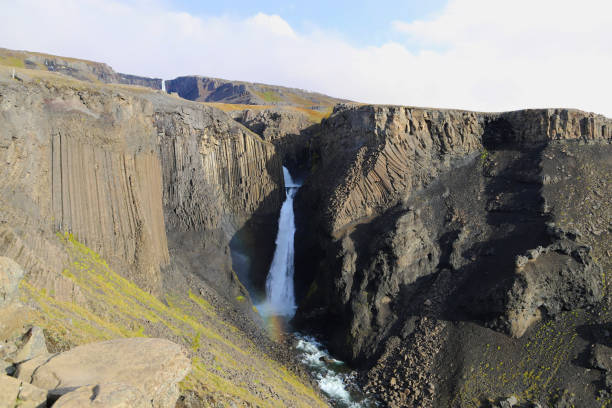 Scenic view of Litlanesfoss - an awesome waterfall framed by the basalt columns. It is located Fljotsdalur valley in East Iceland. stock photo
