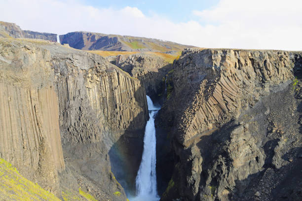 Scenic view of Litlanesfoss. Litlanesfoss waterfall is framed by the basalt columns. stock photo