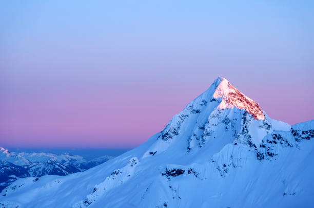 Scenic view of mountain peak at sunrise stock photo