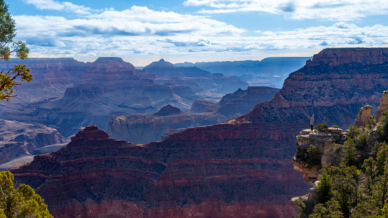 Scenic view of the South Rim of the Grand Canyon. Senior woman standing on the edge of Canyon