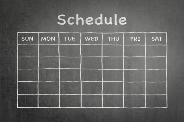 Schedule with grid timetable on black chalkboard  arrival departure board stock pictures, royalty-free photos & images