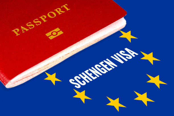 schengen visa, white text over eu flag and passport stock photo