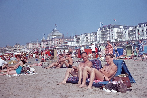 Scheveningen, Den Haag, Zuid-Holland, Netherlands, 1963. The beach of Scheveningen with visitors, bathers and tourists on a sunny summer day. Furthermore: building.