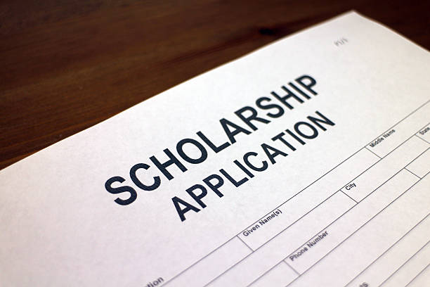 Scholarship Application Form Someone filling out Scholarship Application form scholarships stock pictures, royalty-free photos & images