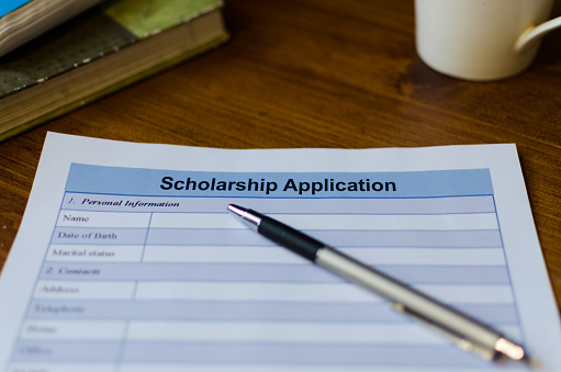 Picture of a scholarship application form and a pen