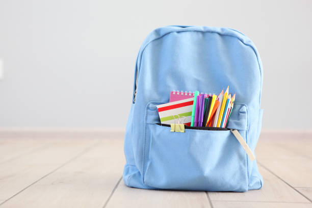 school backpack and stationery in a bright room. Preparing for school. Back to school. Place for text. National School Backpack Awareness Day school backpack and stationery in a bright room. Preparing for school. Back to school. Place for text. National School Backpack Awareness Day backpack stock pictures, royalty-free photos & images