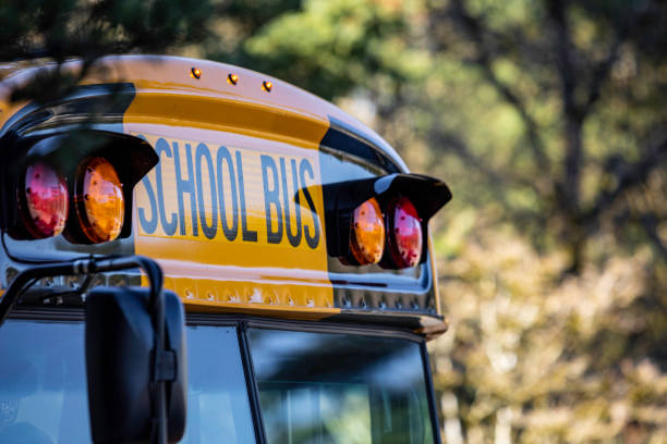 School Bus Front Detail Close Up Yellow school bus for kids shot close up at the front text and windshield school buses stock pictures, royalty-free photos & images