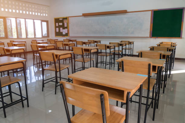 School Closed, Empty Classroom whiteboard without children and teacher. College empty class room no childrens when COVID-19 disease outbreak closed quarantine, Education learning problem in world stock photo