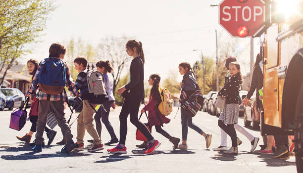 School kids crossing street School kids crossing street crosswalk stock pictures, royalty-free photos & images