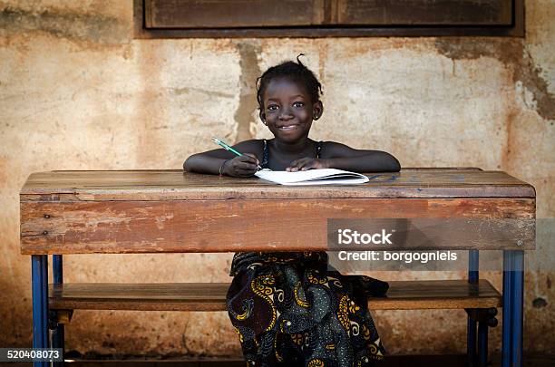 School: Proud African Schoolgirl Sitting In Her Desk Smiling