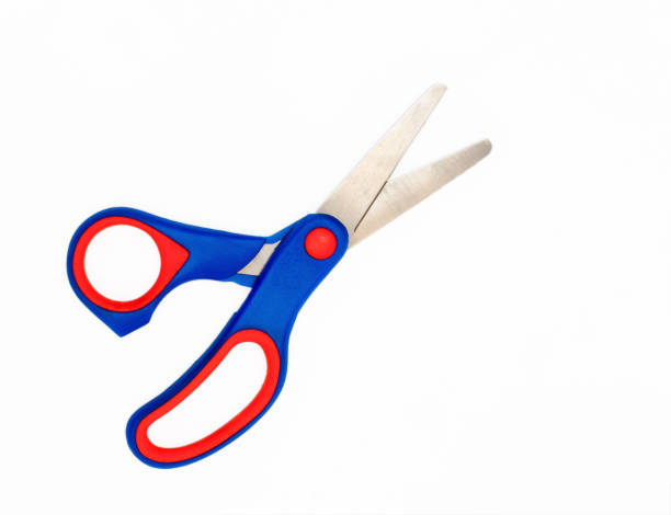 School Scissors open.Pair of blue red handled kids scissors isolated on white background. stock photo