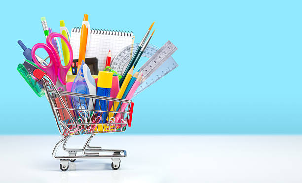 school supplies in shopping cart - back to school School stationery in shopping cart office supply stock pictures, royalty-free photos & images