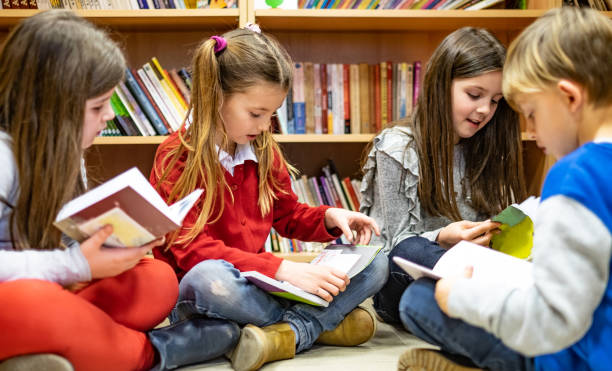 Schoolchildren reading a books stock photo