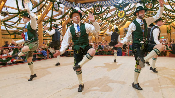 Munich - Germany, September 24, 2014: A traditional Bavarian dancing group performing a traditional dance on stage in a tent at the Octoberfest in Munich, Germany.