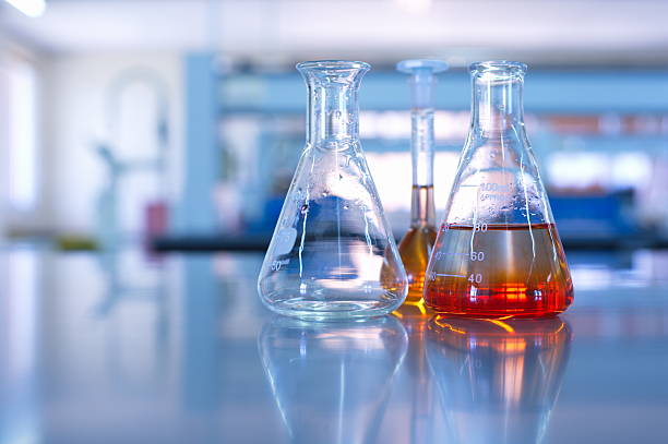science laboratory glassware science laboratory glassware orange solution laboratory glassware stock pictures, royalty-free photos & images