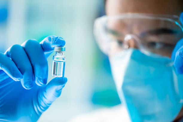 scientist look to newest vaccine close up of scientist microbiologist or medical worker look to newest vaccine in the laboratory ampoule stock pictures, royalty-free photos & images