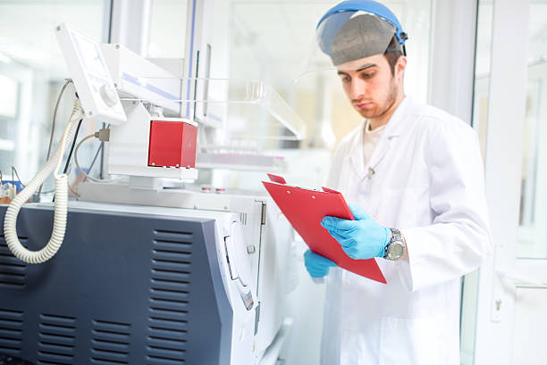 Scientist or doctor using clipboard and reading experiment information stock photo